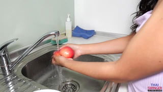 Curvy brunette washing apples uncensored
